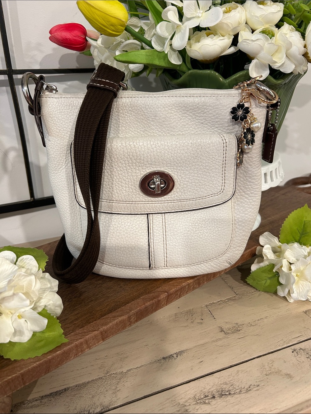 Coach White Pebbled Crossbody with Brown Strap and Floral Charm
